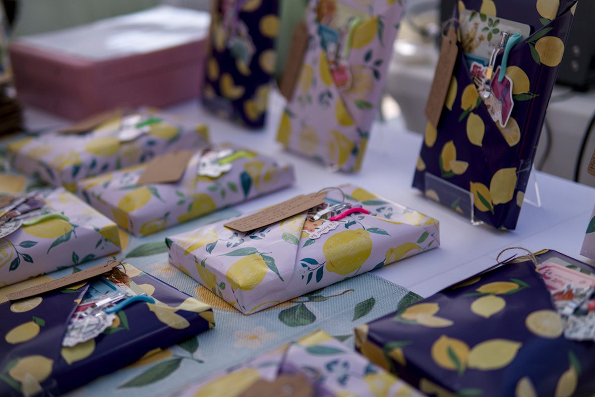 Books gift-wrapped in lemon-print paper with handmade tags